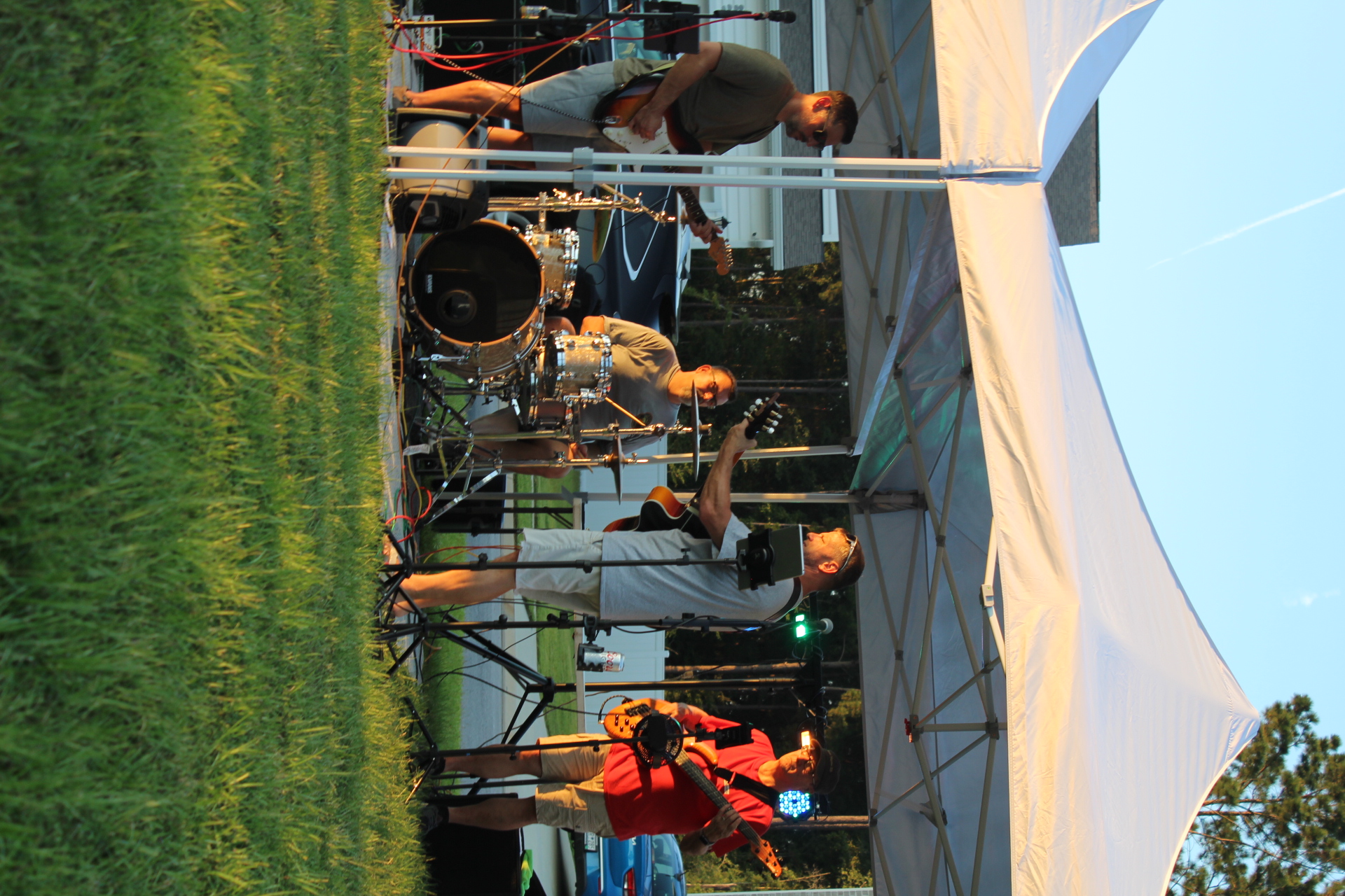 Full band performing at outdoor venue